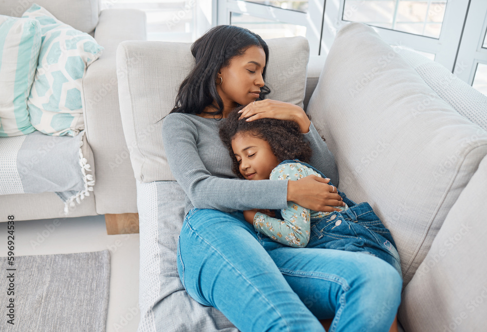 Family means no one gets left behind or forgotten. Shot of a mother and daughter lying on the sofa at home. Family means no one gets left behind or forgotten. Shot of a mother and daughter lying on the sofa at home.