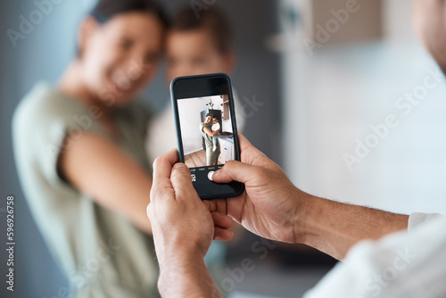 Zoom in on the love. Shot of a young mother taking a picture with her baby at home.