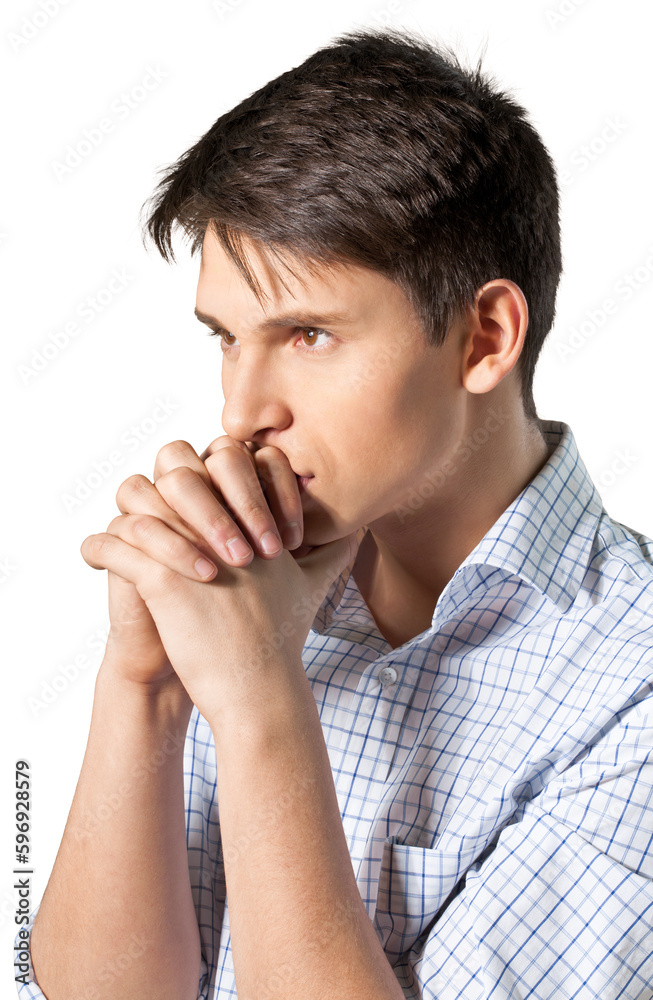 Young man with his arms folded appearing deep in thought Young man with his arms folded appearing deep in thought