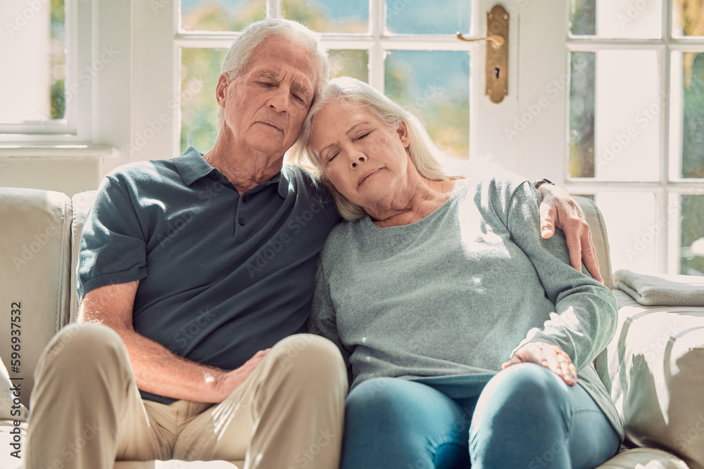 No better place to be. Cropped shot of an affectionate senior couple sitting in their living room at home.