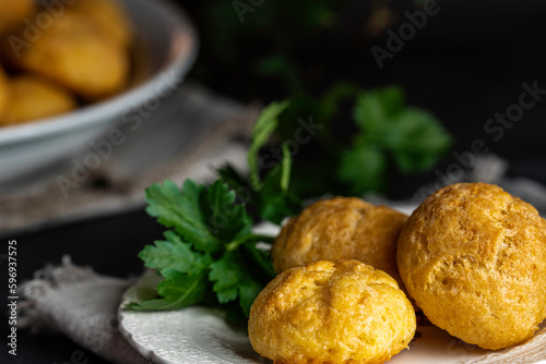 French cheese puffs made from savory choux pastry with cheddar and parmesan cheese, then baked until golden brown.