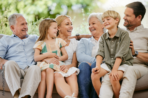 фотографія Happy and smiling multi generation caucasian family sitting close together on the sofa at home