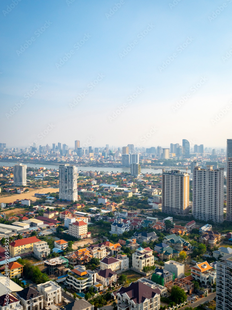 Phnom Penh,Cambodia - April 23 2023: High-angle vertical view of Phnom Penh city skyscraper along Mekong river.