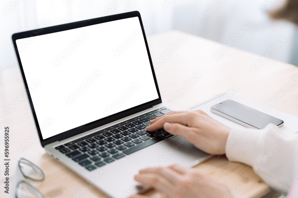 Lady using laptop with white screen on wooden table. Lady using laptop with white screen on wooden table.