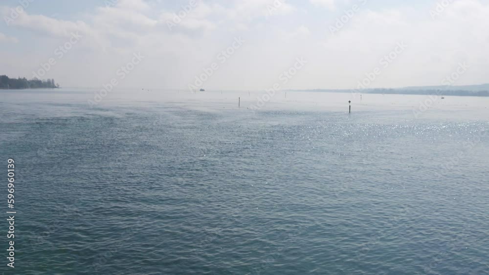 Beautiful and picturesque Lake Constance in the city of Konstanz, Germany, beautiful view from the embankment. Clean transparent water glistens in the sun Beautiful and picturesque Lake Constance in the city of Konstanz, Germany, beautiful view from the embankment. Clean transparent water glistens in the sun