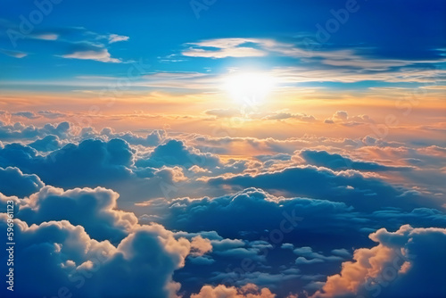 View above the clouds with a blue sky and a bright sun. summer solstice in the orange, white, and blue clouds.
