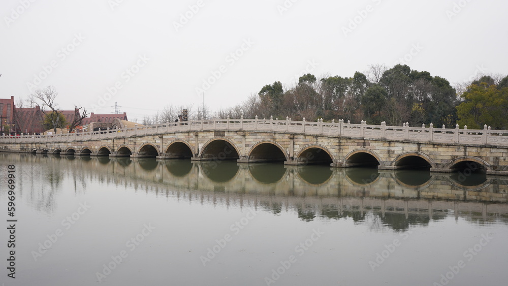 The old stone arched bridge in the park in China