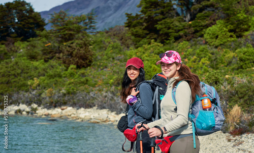 two Chilean young women hikers backpackers smiling cheerful in Torres del Paine National Park