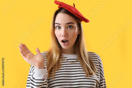 Shocked young woman on yell...