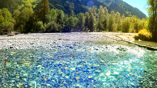 small clear cold river with shingle stones in Arkhyz mountains - photo of nature