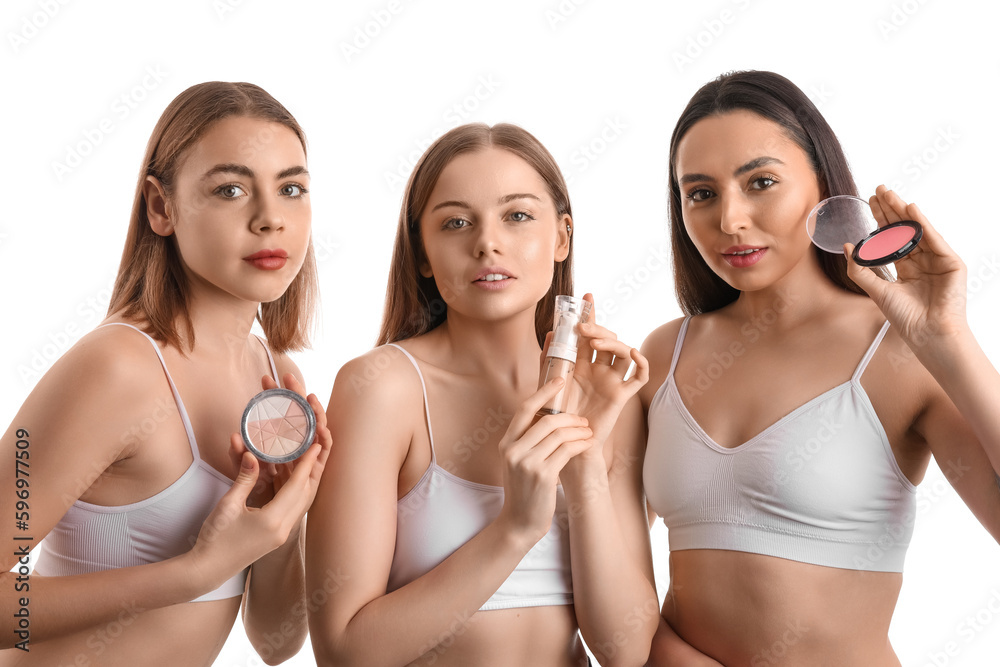 Young women with makeup products on white background Young women with makeup products on white background