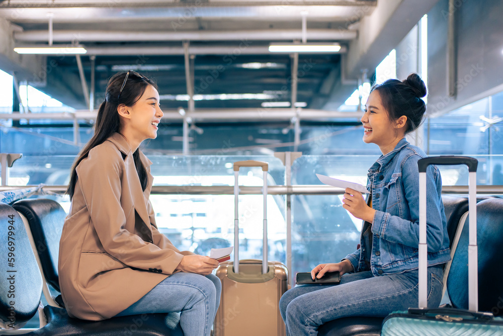 Asian women passenger waiting for airplane boarding at airport terminal. 