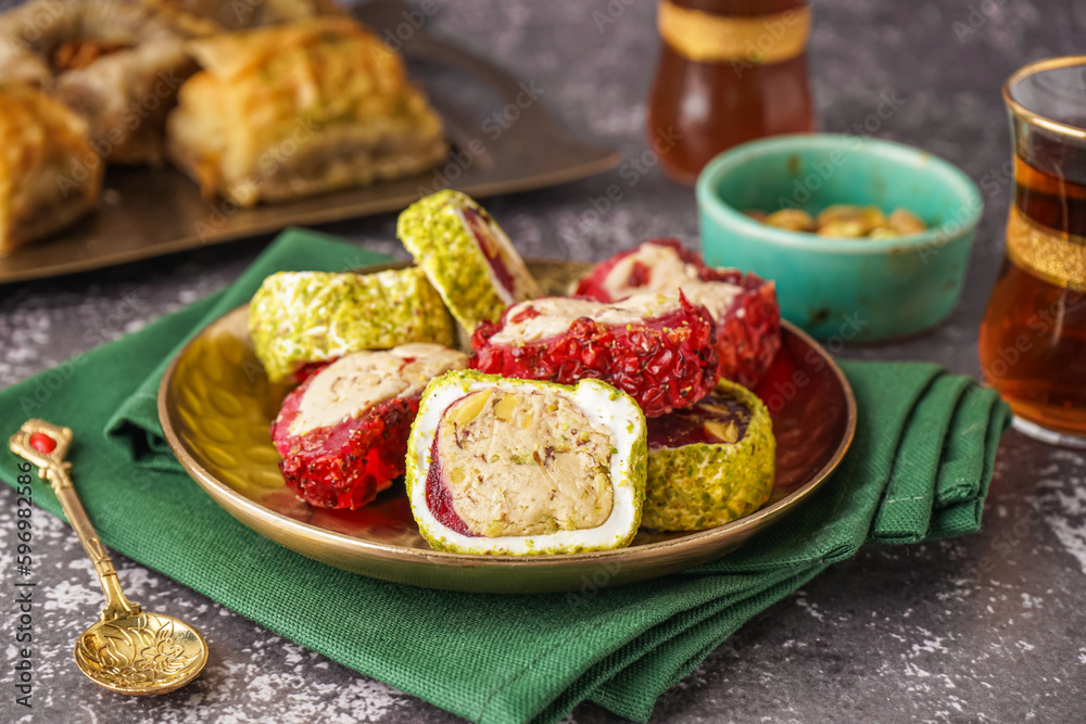Plate with tasty Turkish Delight on grunge background Plate with tasty Turkish Delight on grunge background