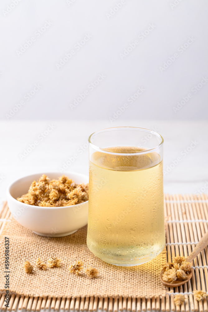 Chrysanthemum tea in glass and dry flowers, Healthy Herbal drink