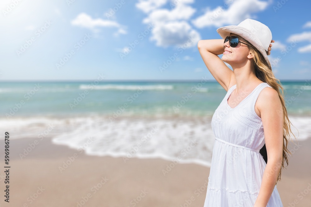 Happy young tourist woman on the beach