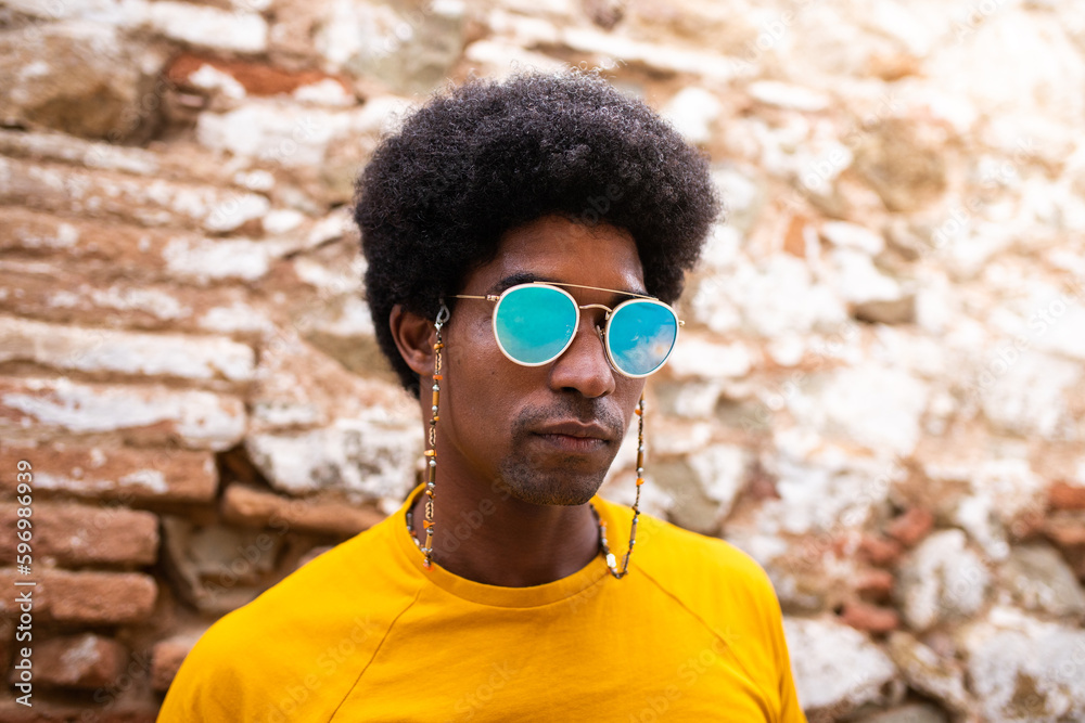 Portrait of cool and confident african american man wearing sunglasses outdoors. Portrait of cool and confident african american man wearing sunglasses outdoors.