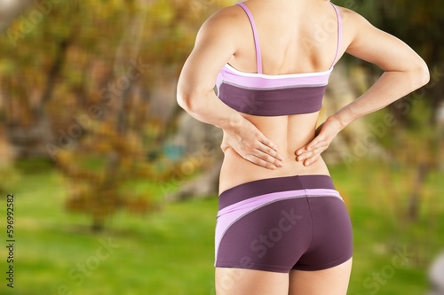 A woman with pain while running in the park