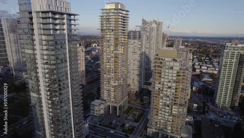 Aerial pan around residential towers revealing city transit centre during an evening in Vancouver, BC photo