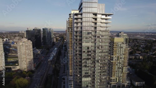 Aerial pan around city center surrounded by skyscrapers and residential towers in Vancouver, BC photo
