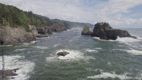 Low aerial drone view of waves Crashing on the Rocky Oregon Coast