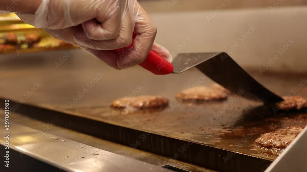 Chef Cooking Burger Meat Using Metal Spatula. Chef Cooking Burger Meat Using Metal Spatula.