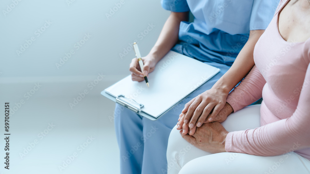 Asian Chinese female physiotherapist caregiver helping elderly woman exercise for recovery, prevention of osteoarthritis and osteoporosis.