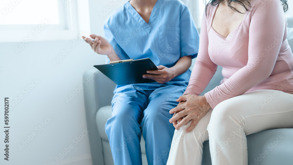 Naklejka premium Asian Chinese female physiotherapist caregiver helping elderly woman exercise for recovery, prevention of osteoarthritis and osteoporosis.
