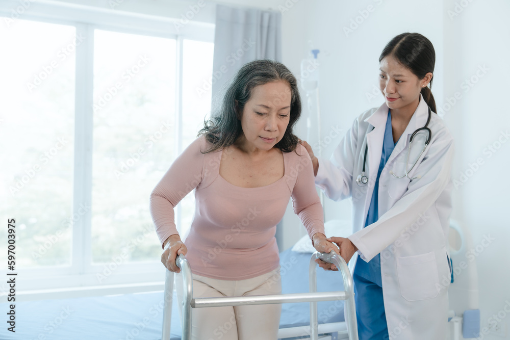 Fototapeta premium Asian Chinese female physiotherapist caregiver helping elderly woman exercise for recovery, prevention of osteoarthritis and osteoporosis.