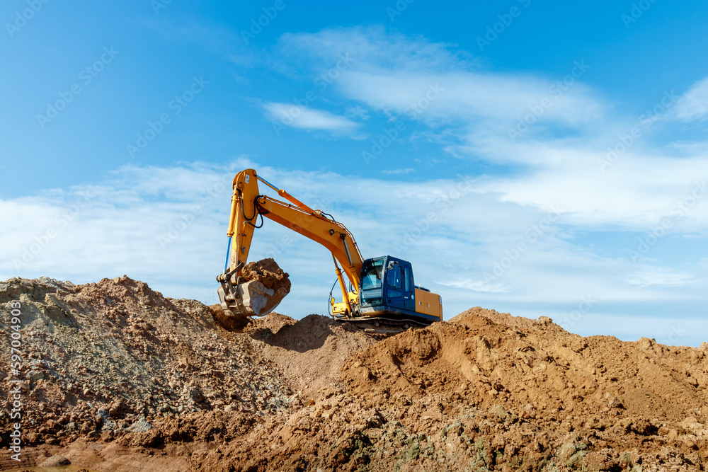 Excavator dig the trenches at a construction site. Trench for laying external sewer pipes. Sewage drainage system for a multi-story building. Digging the pit foundation Excavator dig the trenches at a construction site. Trench for laying external sewer pipes. Sewage drainage system for a multi-story building. Digging the pit foundation