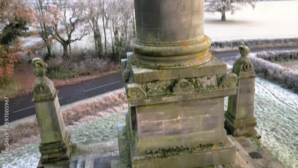 Full Rising drone shot of the monument at Castle Howard showing whole obelisk from bottom to top on snowy and frosty winter day Full Rising drone shot of the monument at Castle Howard showing whole obelisk from bottom to top on snowy and frosty winter day