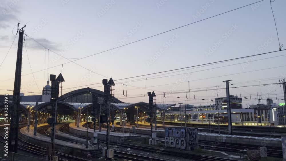 train tracks of cologne main station in the evening with lots of lights train tracks of cologne main station in the evening with lots of lights