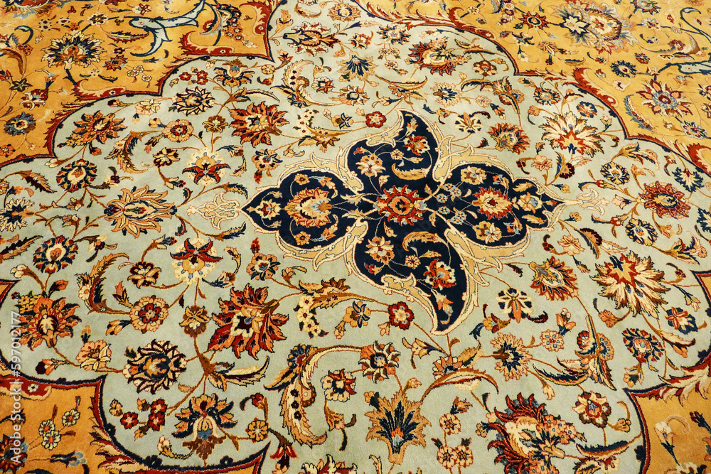 Fragment of oriental ornament of ancient handmade floor carpet close-up