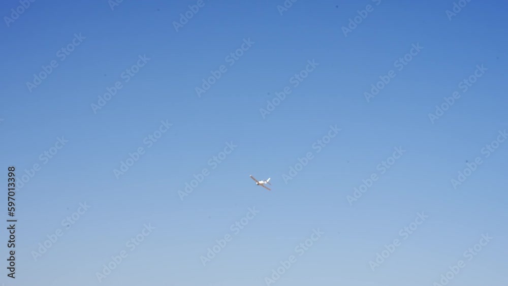 Small propeller-driven airplane Fixed-wing aircraft with rotating airscrew in front moving in the sky Small propeller-driven airplane Fixed-wing aircraft with rotating airscrew in front moving in the sky