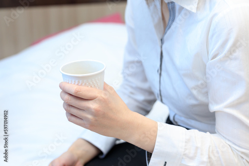 仕事中にコーヒーを飲んで休憩している女性 ノートパソコン ビジネス
