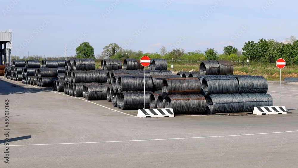 Steel wire rods just manufactured in the outdoor warehouse storage of the steel mill. Steel wire rods just manufactured in the outdoor warehouse storage of the steel mill.