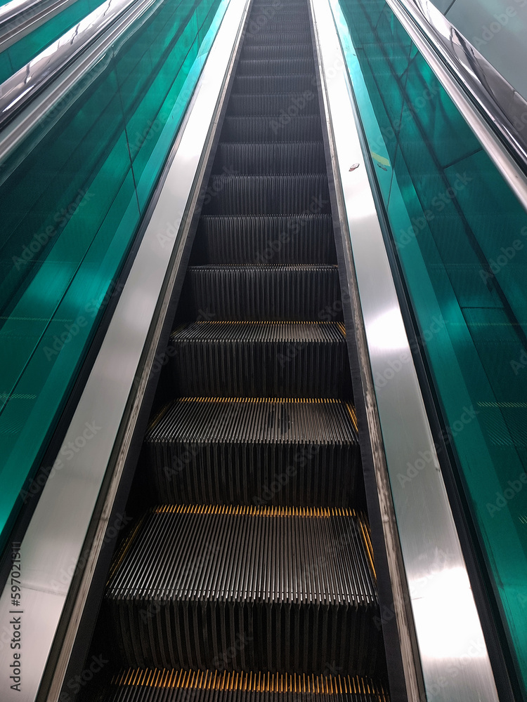 An escalator going up without anyone. An escalator going up without anyone.