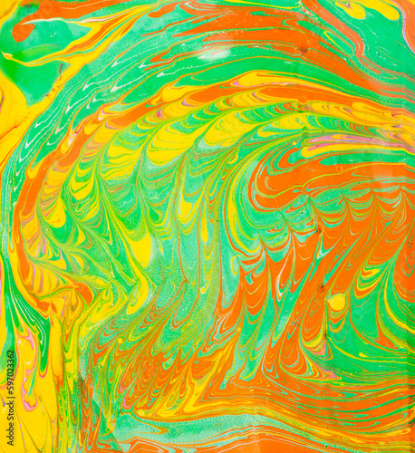 Ink marble texture. Ebru handmade background. Abstract green orange and yellow background. Unique art illustration. Liquid marbling texture.