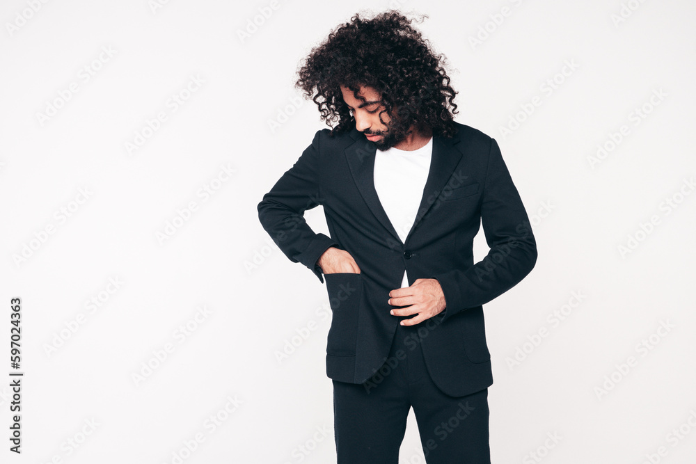Handsome smiling hipster model. Unshaven Arabian man dressed in summer suit jacket clothes. Fashion male with long curly hairstyle isolated on white in studio. Cheerful and happy Handsome smiling hipster model. Unshaven Arabian man dressed in summer suit jacket clothes. Fashion male with long curly hairstyle isolated on white in studio. Cheerful and happy