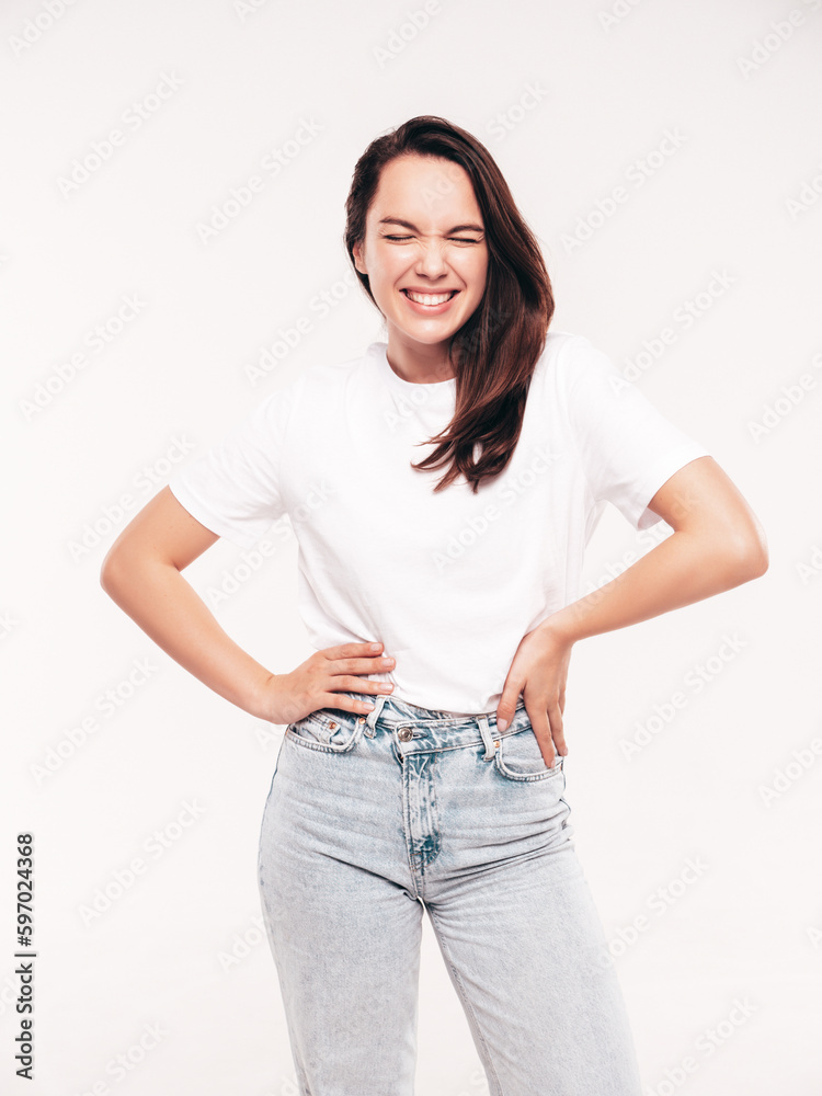 Young beautiful woman. Trendy carefree model in casual summer white T-shirt and blue jeans. Positive female isolated on white in studio. Cheerful and happy. Copy space, mockup Young beautiful woman. Trendy carefree model in casual summer white T-shirt and blue jeans. Positive female isolated on white in studio. Cheerful and happy. Copy space, mockup