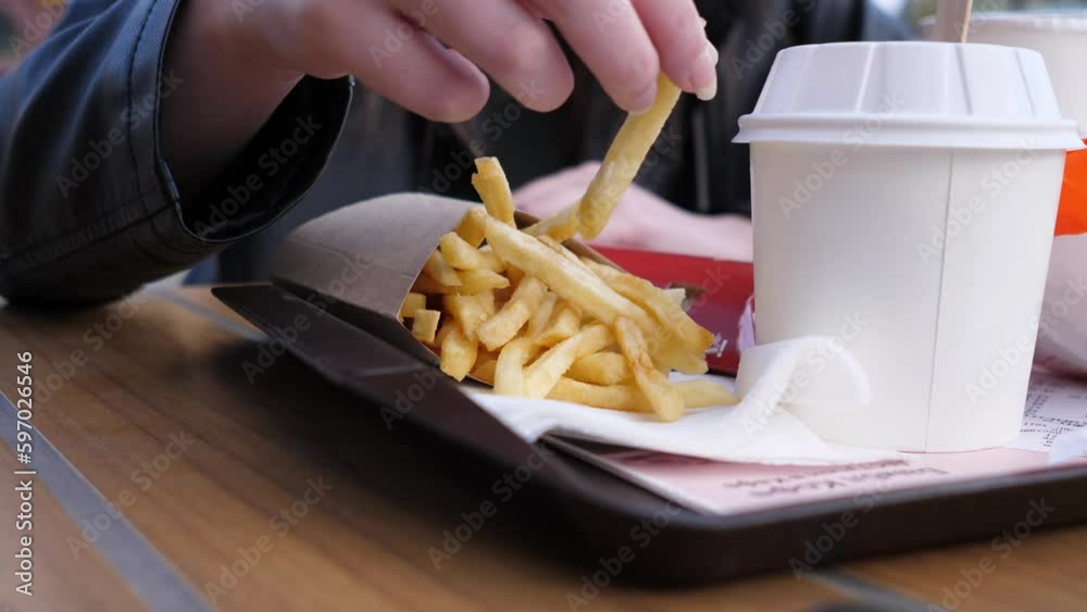 women's hands and French fries close 4k women's hands and French fries close 4k