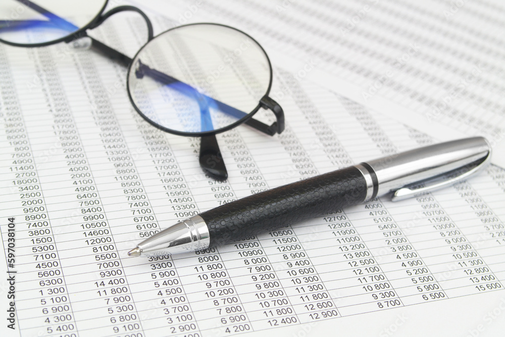 Black glasses and pen on financial papers. Business concept. Black glasses and pen on financial papers. Business concept.