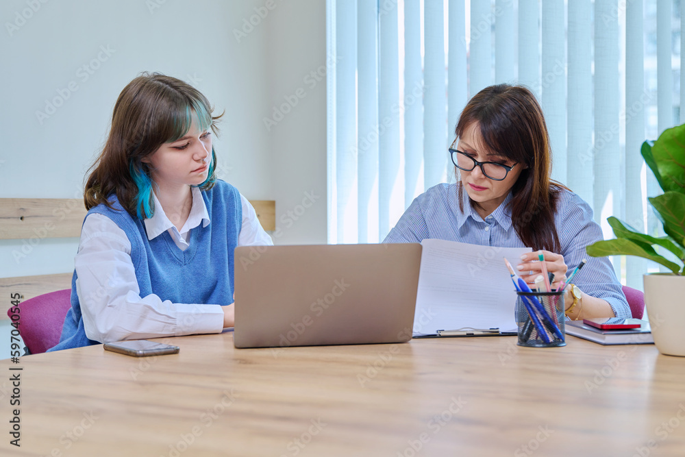 Woman social worker, mentor interviewing, talking to young teen female in office - obrazy, fototapety, plakaty 