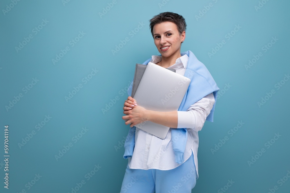 european young brunette woman with tousled hair works remotely using laptop european young brunette woman with tousled hair works remotely using laptop