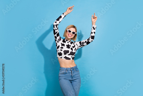 Photo of excited carefree stunning lady enjoy dancing clubbing isolated on blue color background