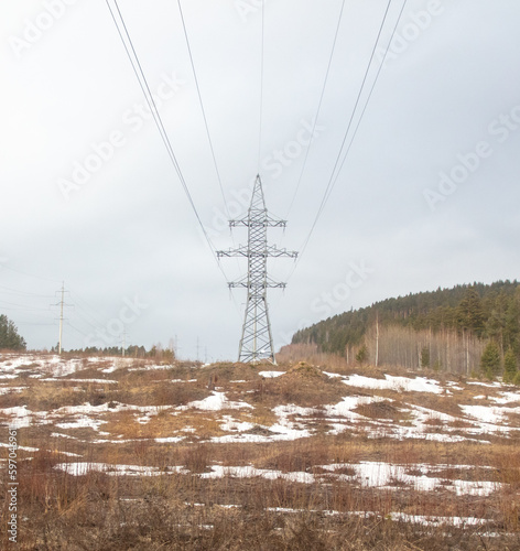 Power line in the middle of the forest. Beautiful winter landscape © schankz