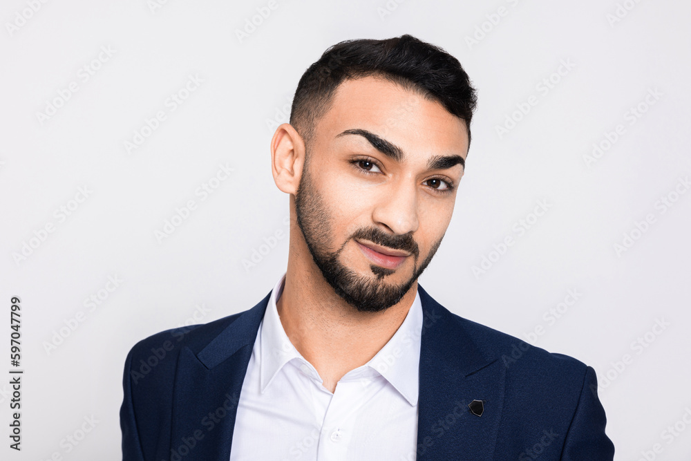 Serious smart handsome guy portrait of young buisnessman wearing smart suit and white t-shirt standing over white background in studio smiling. Serious smart handsome guy portrait of young buisnessman wearing smart suit and white t-shirt standing over white background in studio smiling.