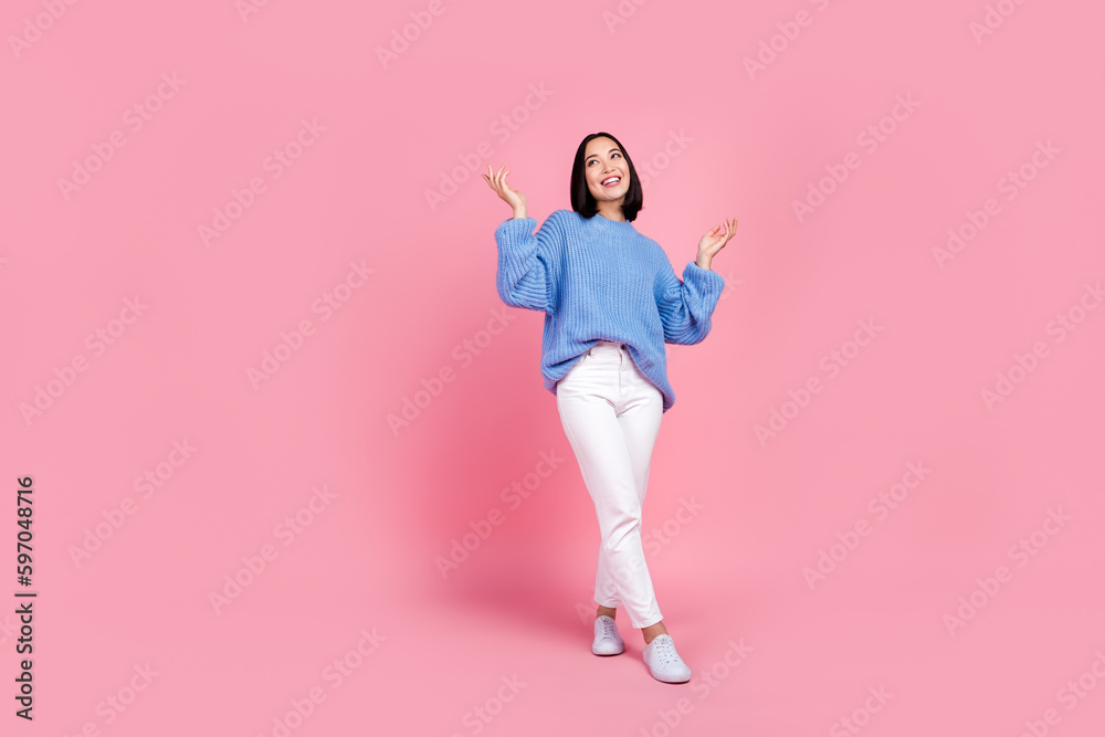 Full length portrait of cheerful satisfied person raise arms empty space isolated on pink color background