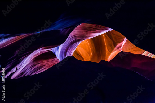 Antelope Canyon in the Navajo Reservation Page Northern Arizona. Famous slot canyon. Rock texture with purple, magenta, blue and orange colors. Rock formation, game of