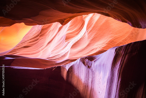 Antelope Canyon in the Navajo Reservation Page Northern Arizona. Famous slot canyon. Light showing off the glamorous detail of the ancient spiral rock arches. Myriad of shadows and soft bright colors.