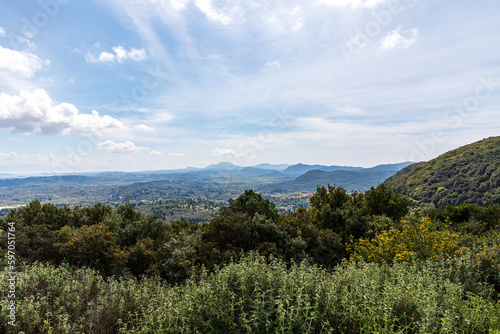 A beautiful landscape of the island of Corfu in the Ionian Sea in Greece. Mountains with plenty of green vegetation. Thick clouds over the island. 